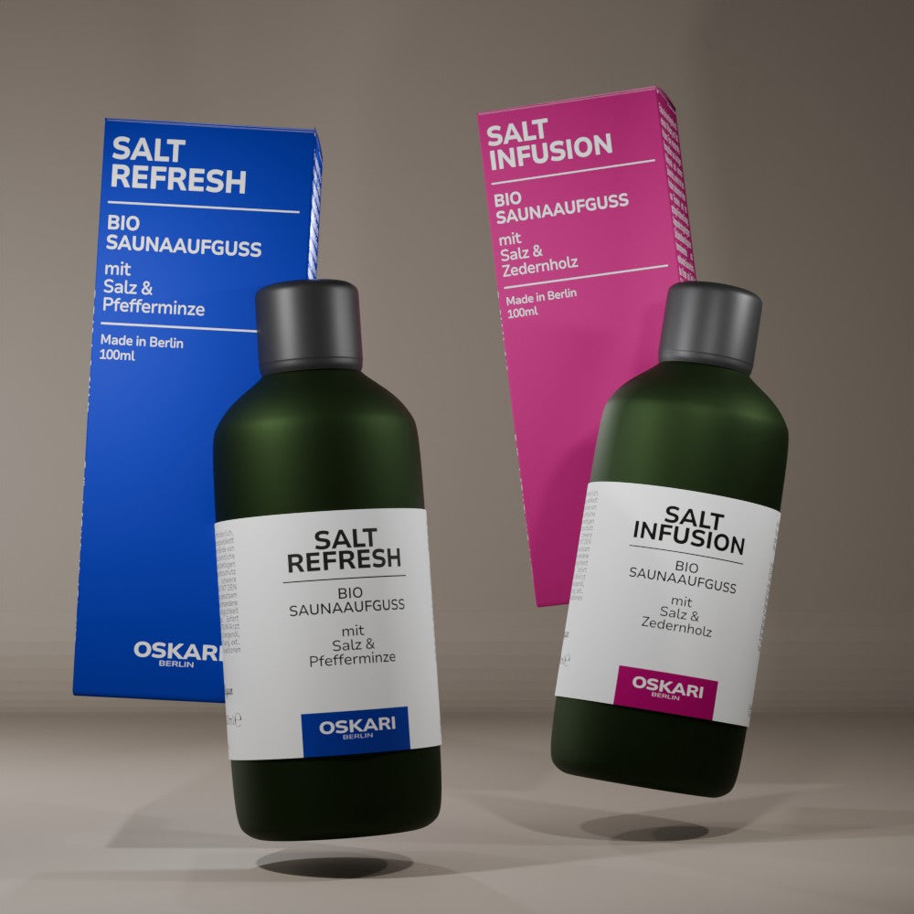 Bio Aufguss Salt Refresh und Salt Infusion dynamische Aufnahme vor grauem Hintergrund mit den beiden intensiv leuchtenden Schachteln in Pink und Blau