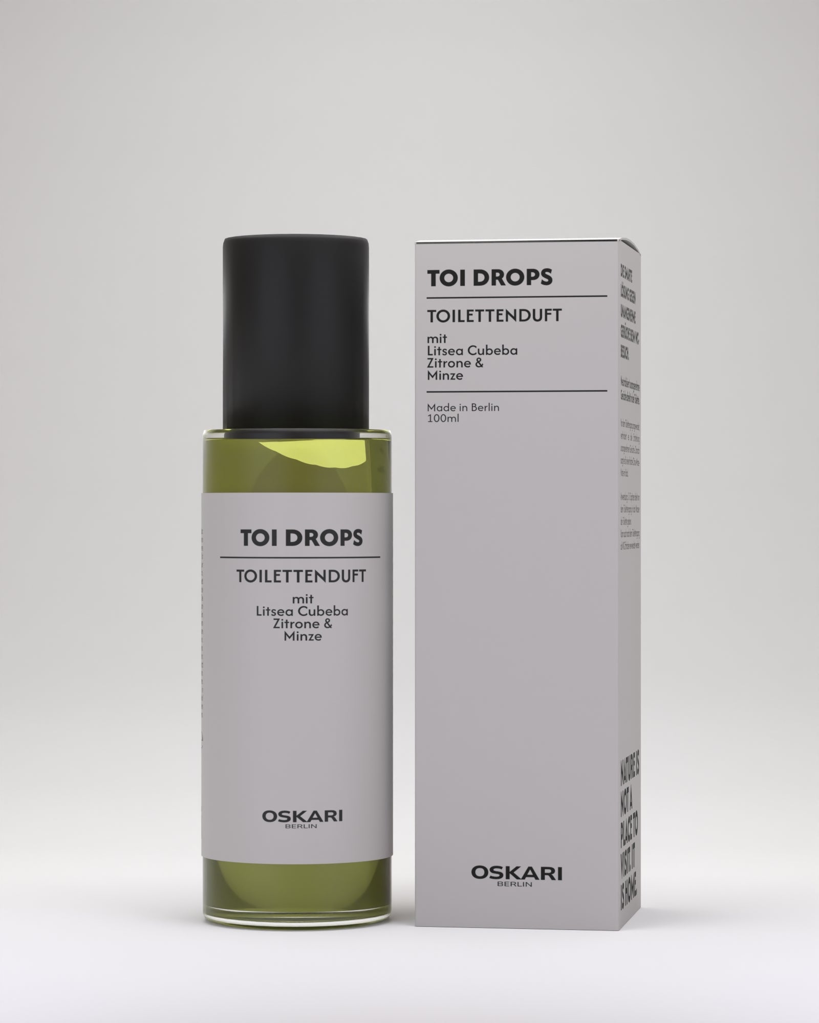 WC Duft Toi Drops mit Klarglasflasche mit schwarzer Kappe und moderner grauer Schachtel vor hellgrauem Hintergrund